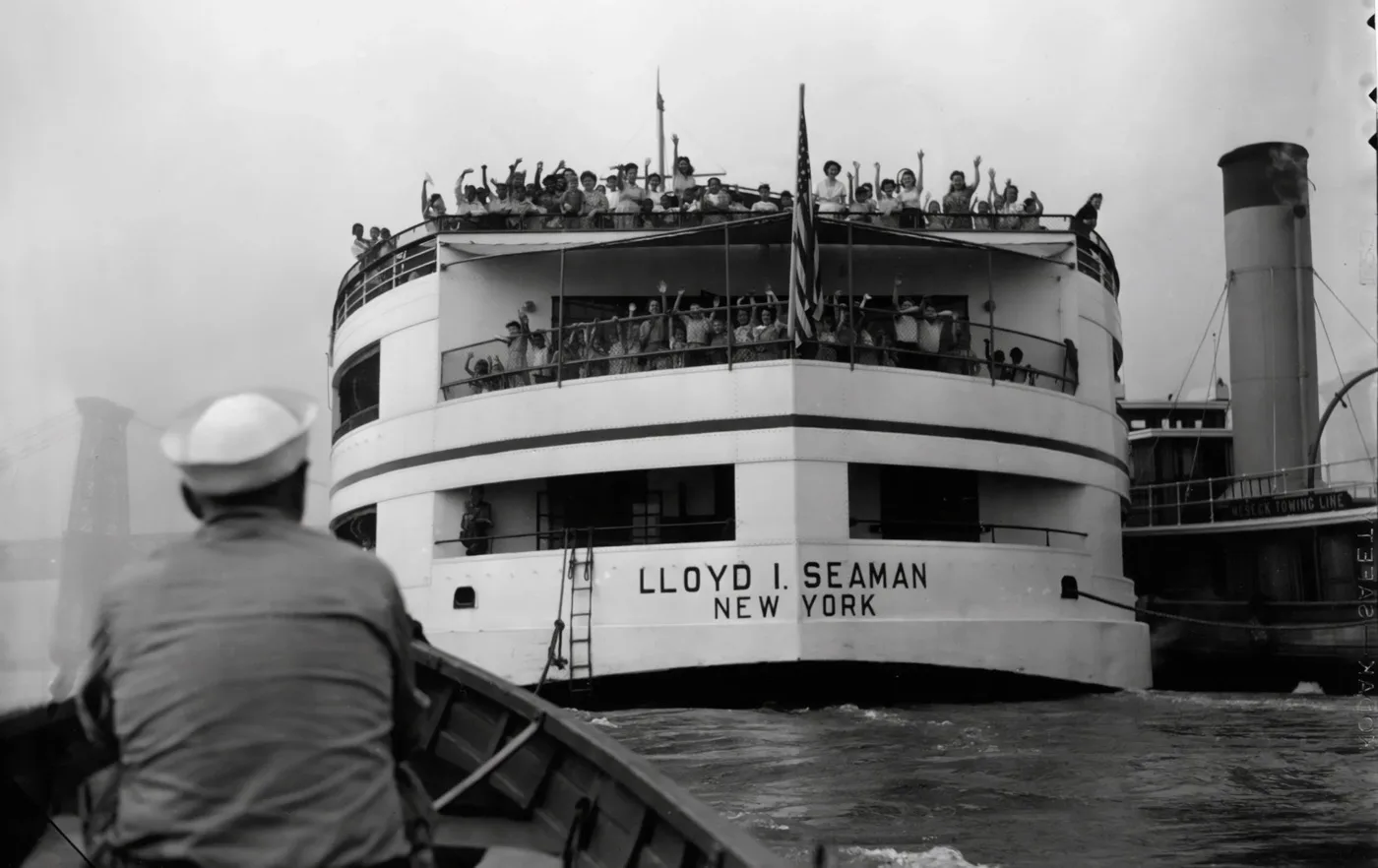 The historic Floating Hospital ship Lloyd I. Seaman with passengers waving from the decks