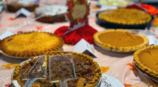 A table of homemade pies at a Thanksgiving gathering