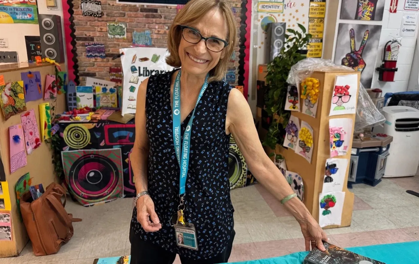 A volunteer among shelves of donated books