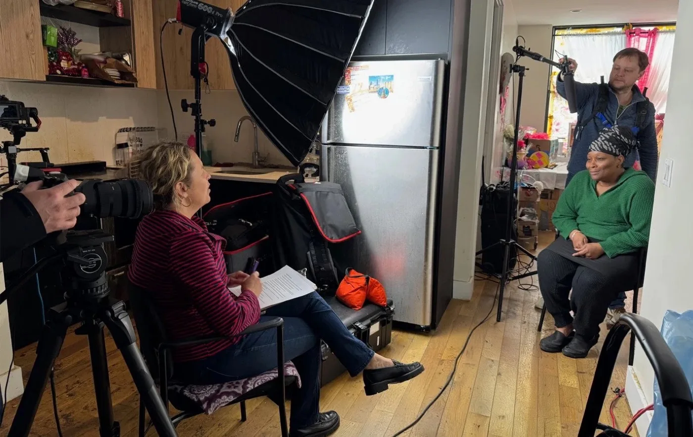 A video shoot in progress with lighting equipment and crew