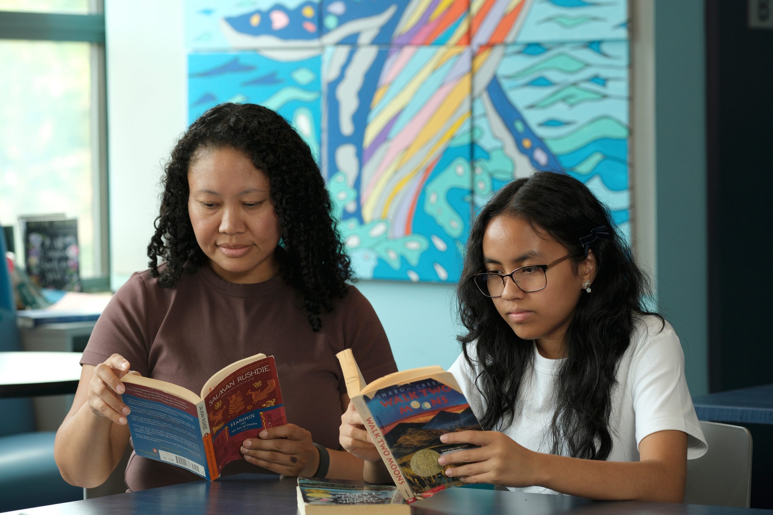 A girl reads a book, overlapping accent photo